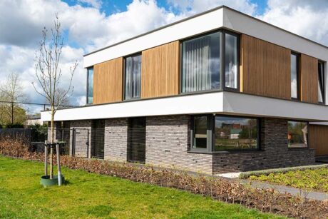 Contemporary real estate houses with green backyards